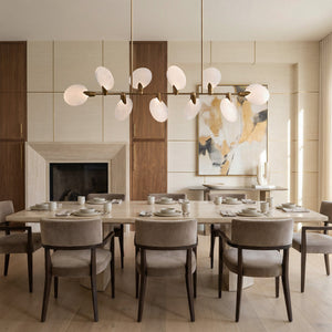 Lyla alabaster linear chandelier in an elegant dining room with fireplace and abstract art