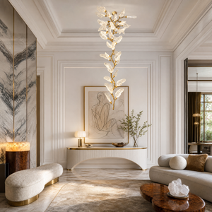 A brass branch-inspired chandelier featuring cascading frosted leaf-shaped glass shades hanging vertically.