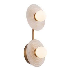 Dahlia brass wall sconce angled view with glowing white glass orbs