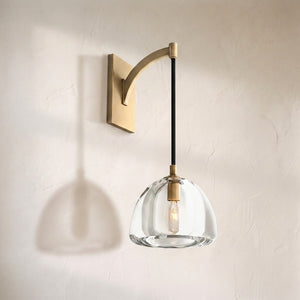 Haloid glass wall sconce, clear dome shade suspended from a curved brass arm