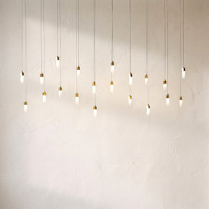 Leo rectangular chandelier with longer drops, the twenty opal pendants staggered across a plaster wall
