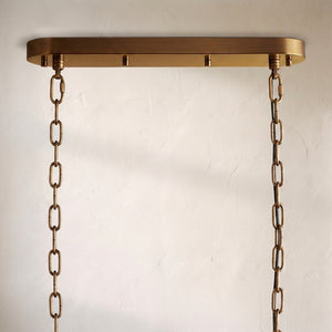 Detail of the Neve chandelier's oval brass canopy and twin suspension chains