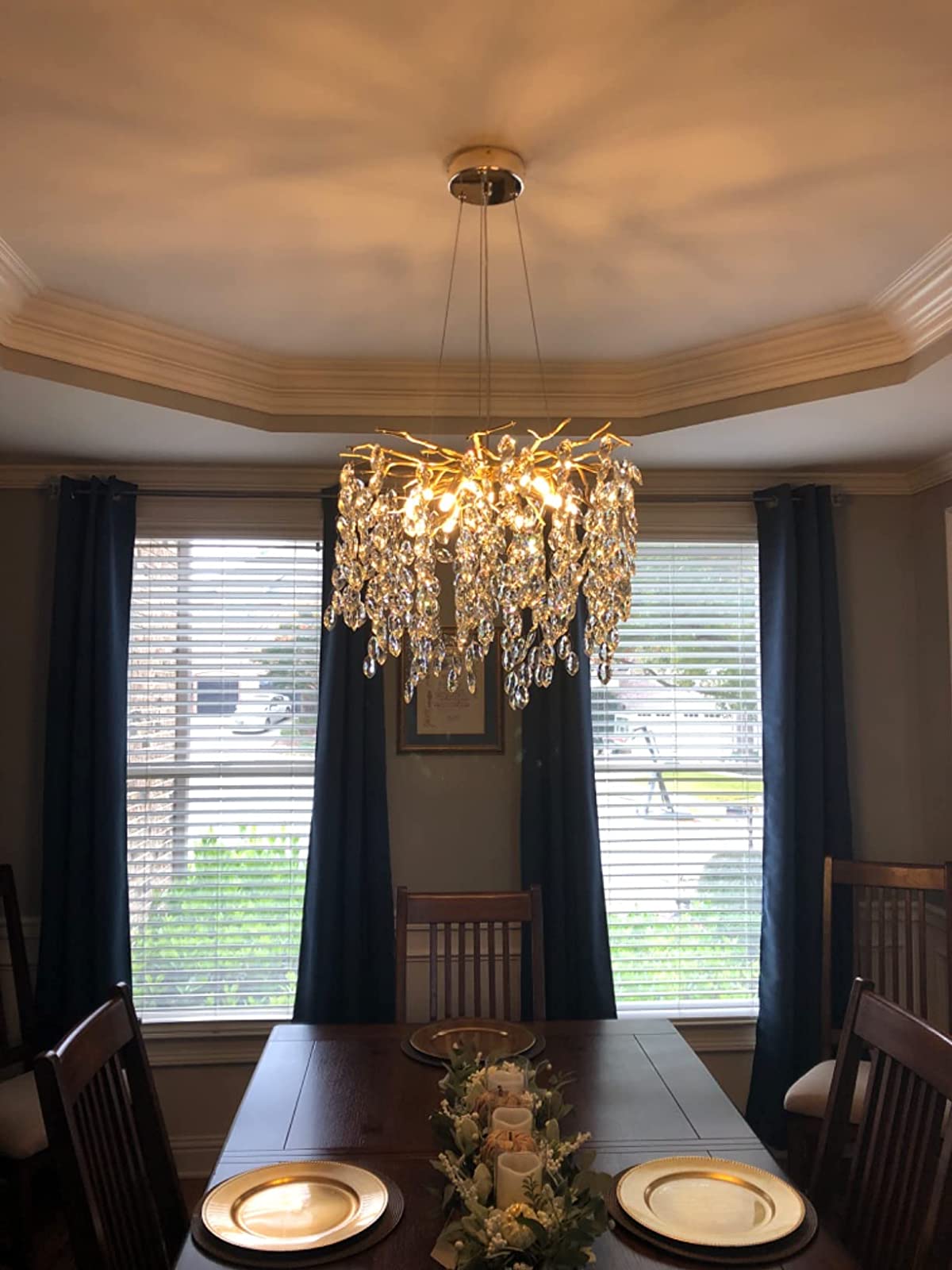 Crystal chandelier above a dining table, RHL Lighting