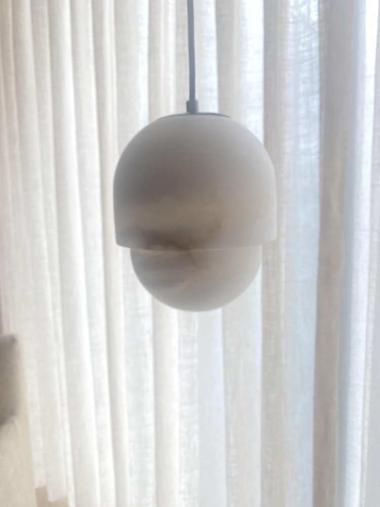 Alabaster pendant light by a window, RHL Lighting