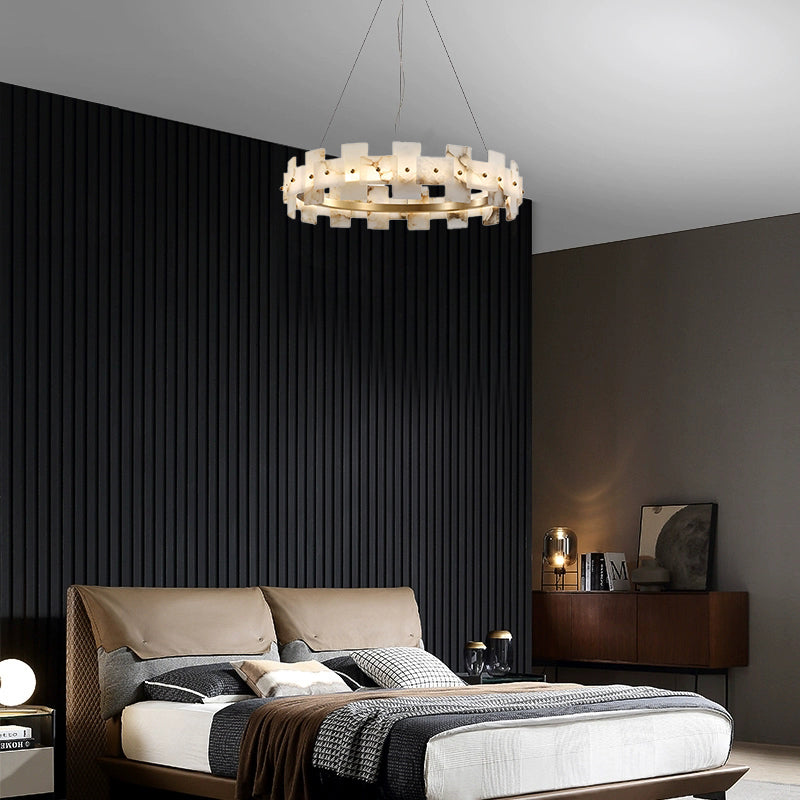 Alabaster chandelier above a bed against a dark slatted wall