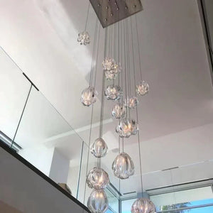 Staircase glass cluster chandelier viewed from the landing with mirror reflection