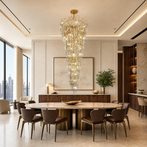 A gold metal branch frame supports a cascading waterfall of clear crystal teardrop prisms in this luxury chandelier.