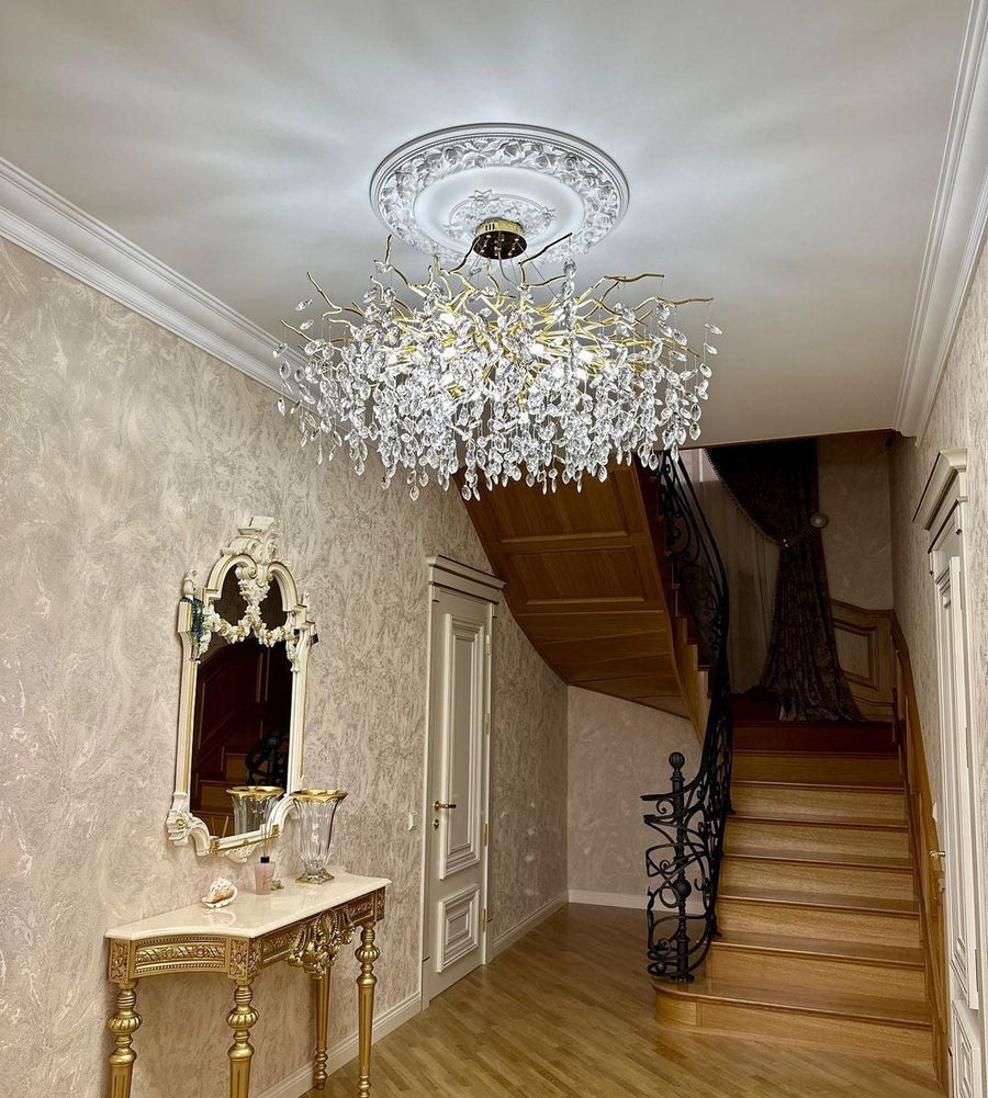 Branch crystal chandelier suspended in a stairwell