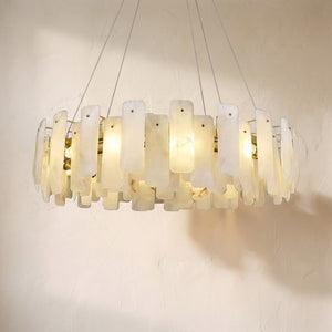 August alabaster round chandelier, overlapping backlit alabaster flakes on a brass drum frame
