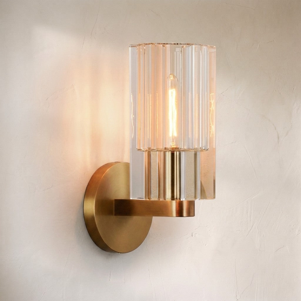 Auraline crystal wall sconce, fluted crystal cylinder shade on a brass bracket and round backplate