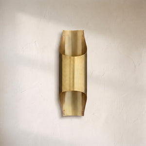 Coren wall sconce, curved brushed brass sheet folded into a tall vertical wall shade