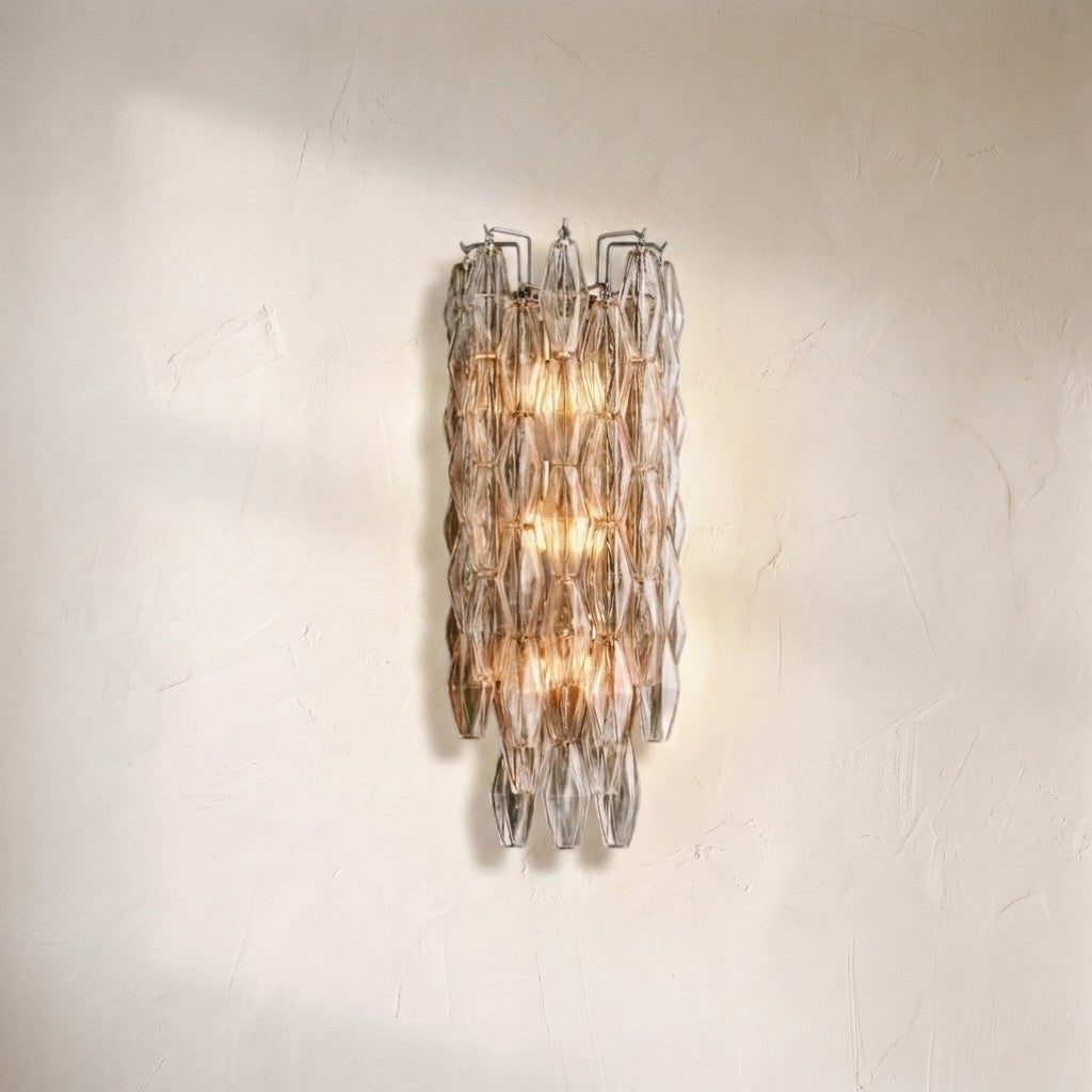 Cyra glass wall sconce, stacked faceted glass prisms in clear and amber glowing from within