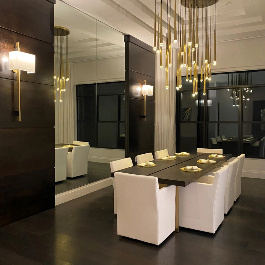 Brass chandelier above a dark wood dining table in a contemporary dining room