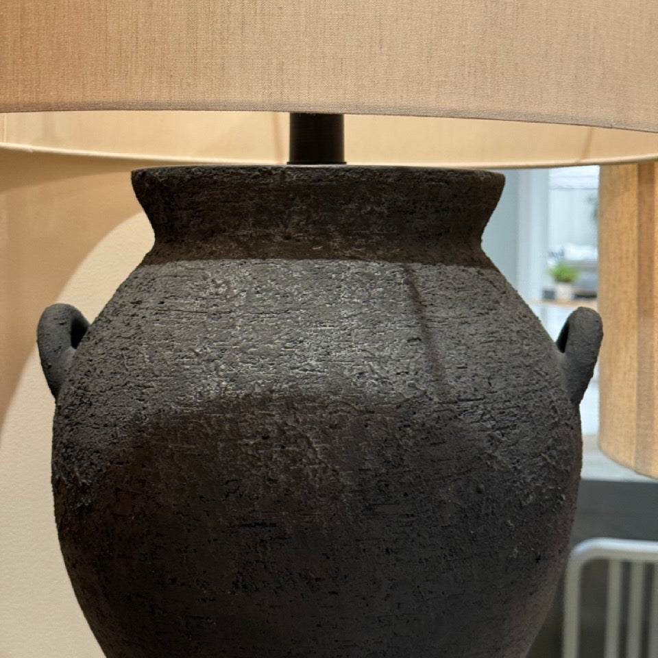 Table lamp with textured black base and beige lampshade