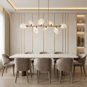 Lyla linear chandelier centered over a long marble dining table in a cream modern dining room