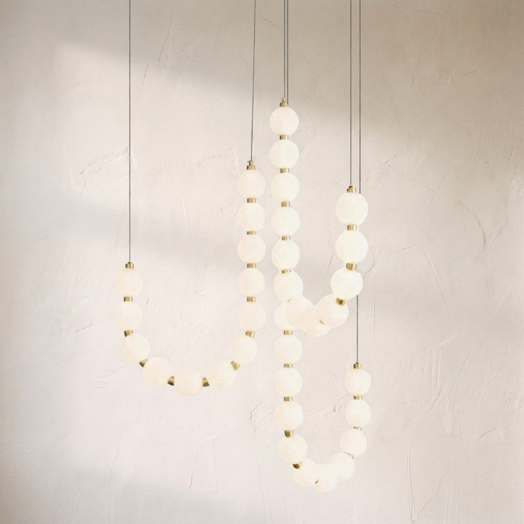 Glass pearl necklace chandelier, strands of frosted glass spheres draped like beads on brass links