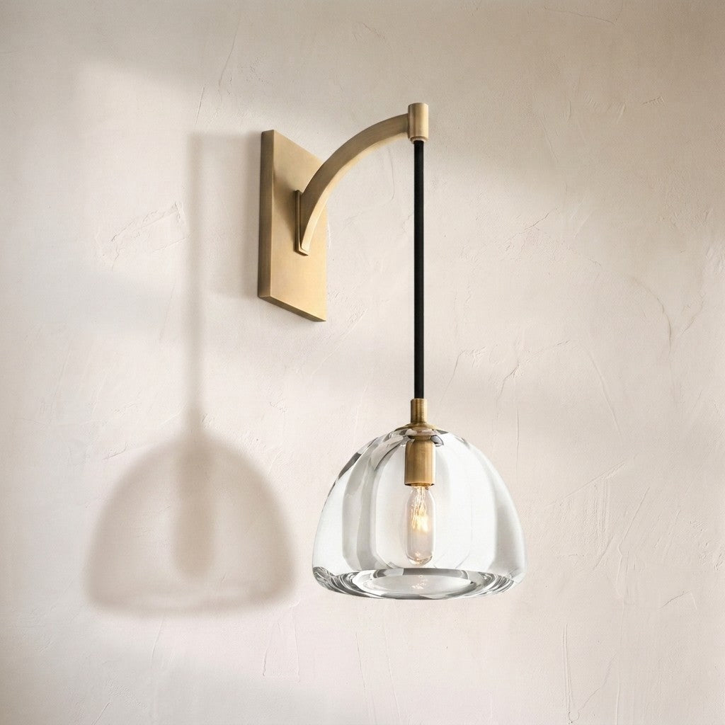 Haloid glass wall sconce, clear dome shade suspended from a curved brass arm