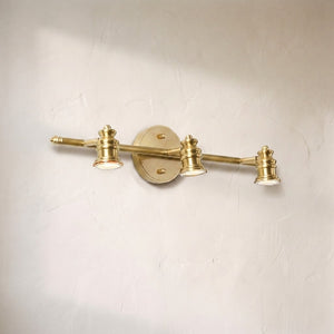 Halophane brass wall lamp, three adjustable brass spotlight heads on a horizontal bar