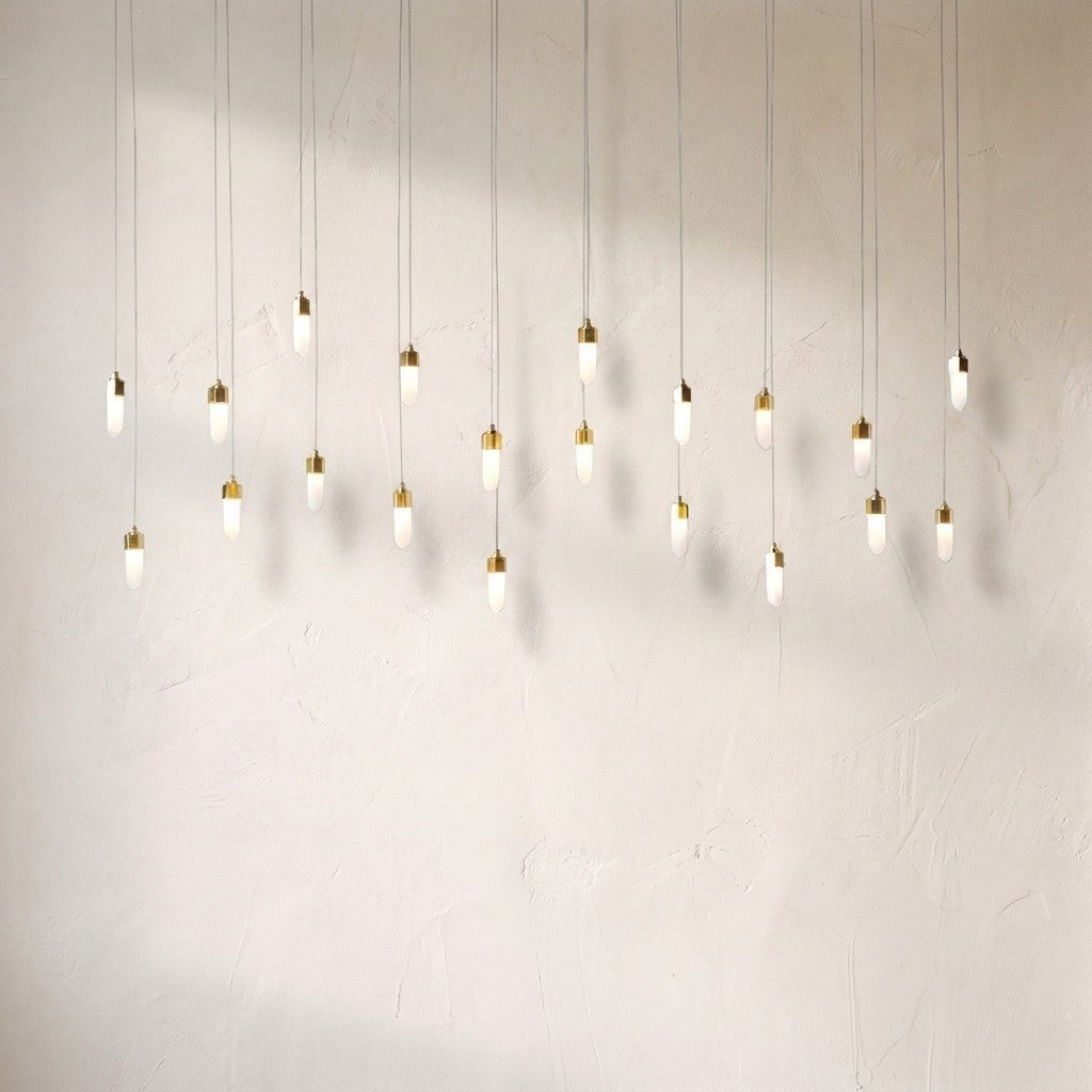 Leo rectangular chandelier at full drop length, twenty opal glass pendants on fine cords casting soft shadows