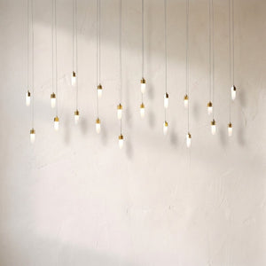 Leo rectangular chandelier at full drop length, twenty opal glass pendants on fine cords casting soft shadows