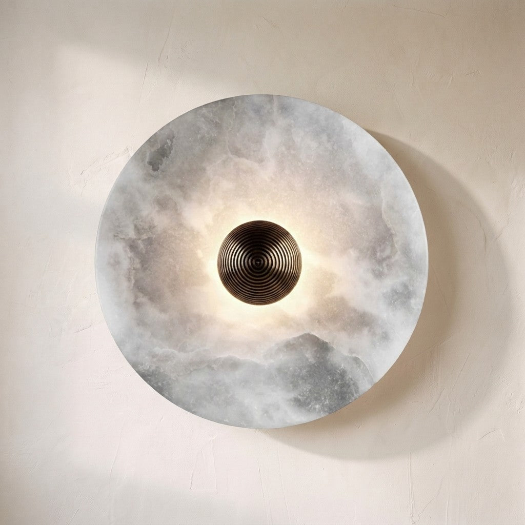 Lunara disc wall sconce, backlit alabaster disc with a ribbed bronze centre boss