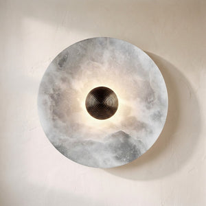 Lunara disc wall sconce, backlit alabaster disc with a ribbed bronze centre boss
