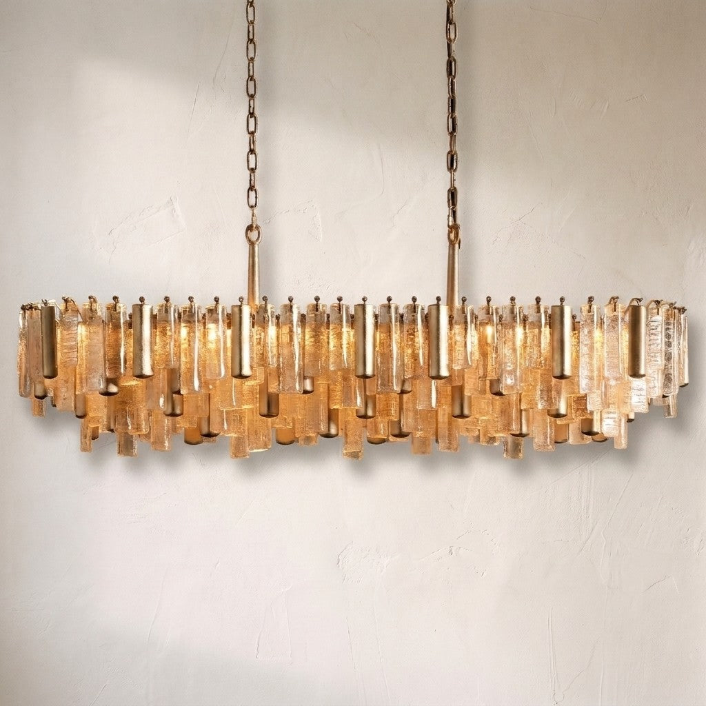 Neve linear chandelier in amber glass, long brass frame packed with textured glass batons on twin chains