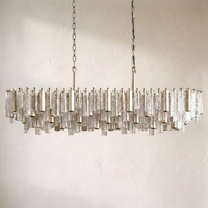 Neve linear chandelier in clear glass with a silvered frame, the same linear form in an alternate finish