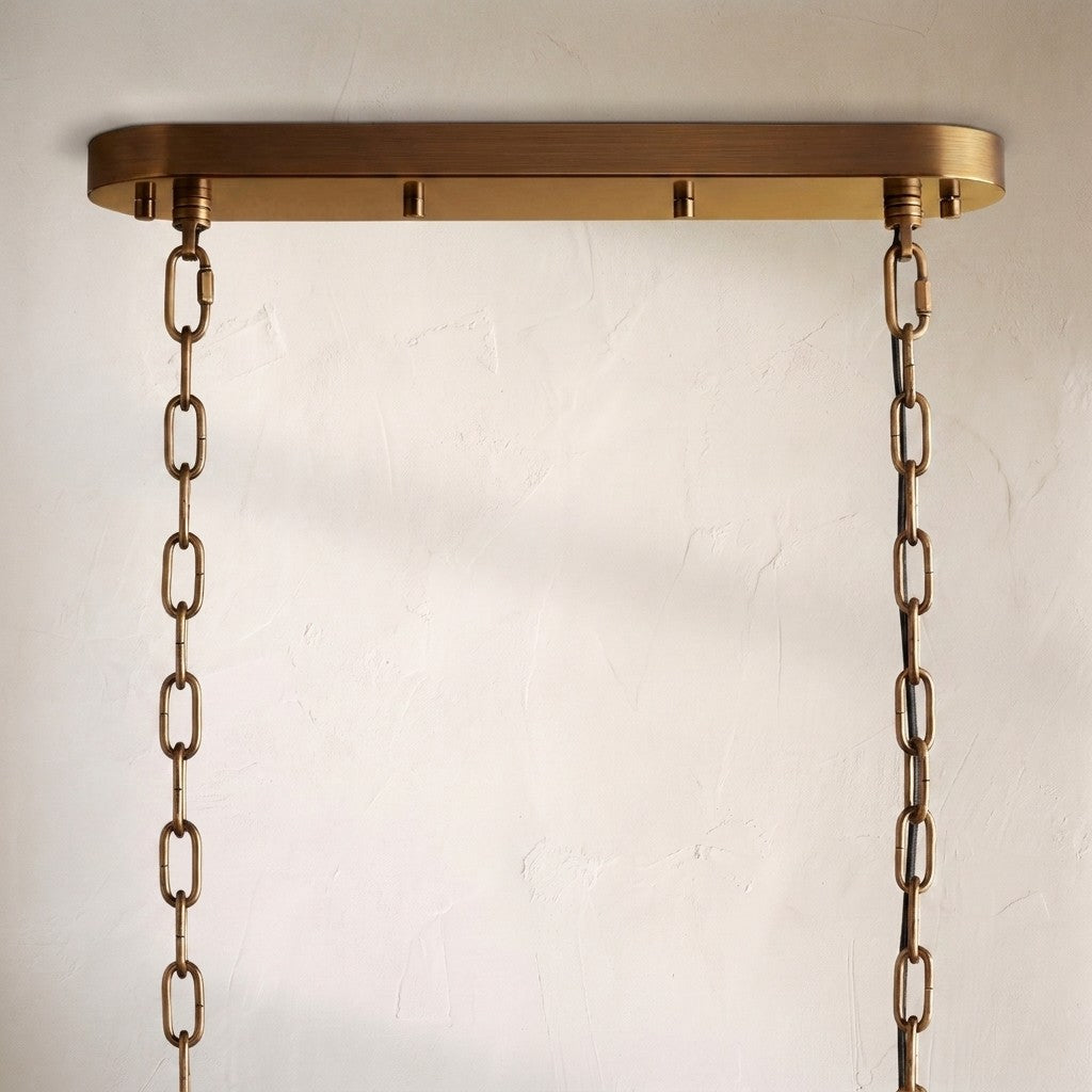 Detail of the Neve chandelier's oval brass canopy and twin suspension chains